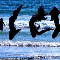 three-girls-jumping-on-the-beach