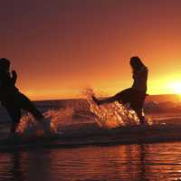 two-girls-kicking-water