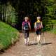 two-kids-walking-with-ski-poles