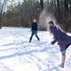 two-people-snowball-fighting-in-the-winter
