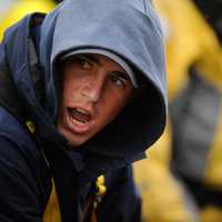 U.S. Coast Guard First Class Daniel Piazza shouts while pulling in line Monday, July 4, 2011, aboard the Coast Guard Cutter Eagle in the Atlantic Ocean south of Greenland.  Piazza is one of 137 cadets training aboard the Eagle during the 2011 Summer Training Cruise, which commemorates the ship's 75th anniversary.  U.S. Coast Guard photo by Petty Officer 1st Class NyxoLyno Cangemi