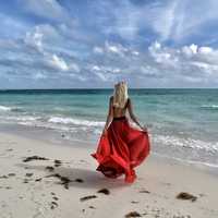 woman-by-the-seaside-in-the-backless-red-dress
