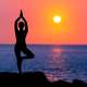 woman-doing-yoga-at-sunset