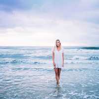 woman-dress-in-white-standing-in-the-sea