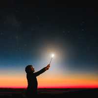 woman-holding-candle-light-up-to-sky