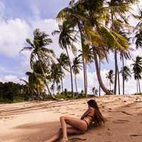 woman-in-black-bikini-on-tropical-sandy-beach