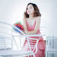 woman-in-pink-dress-sitting-at-table