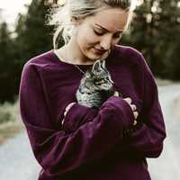 woman-in-purple-shirt-holding-a-kitten