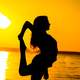 woman-stretching-at-sunrise-on-the-beach