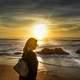 woman-walking-on-the-beach-during-sunset