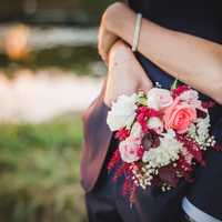 woman-with-arms-wrapped-around-a-man-with-bouquet-flowers