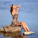 women-sitting-by-the-water-in-leopard-dress