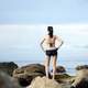 women-standing-at-seaside-in-bathing-suit