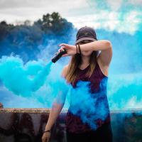Women wave around blue smoke wand