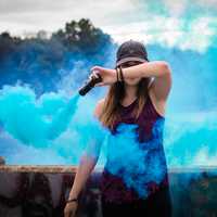 women-waving-around-blue-smoke-wand