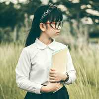 young-girl-in-glasses-holding-notebook