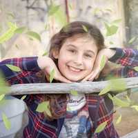 young-girl-smiling-with-face-between-hands