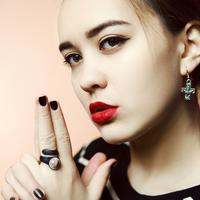 Young Woman face portrait making a gun with hands