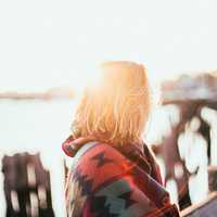 young-women-relaxing-by-the-ocean-on-a-sunny-day