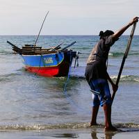 Fisherman bringing in the boat in the Philippines