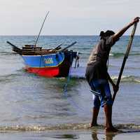 Fisherman bringing in the boat in the Philippines