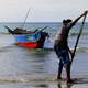 Fisherman bringing in the boat in the Philippines