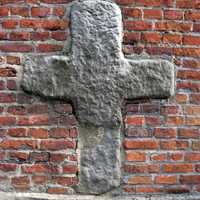 Romanesque cross on the north wall of St. Bartholomew's Church in Konin