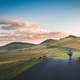 Cyclist with hills and clouds in the distance in Piatra Arsa, Romania