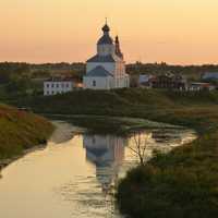 Landscape of church next to a river at dusk in Russia