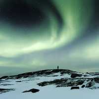 Man watching Aurora Borealis in Teriberka, Russia