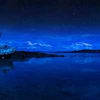 Night lake landscape with boat in Scotland