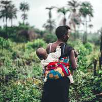 Mother Carrying Baby on Back in Sierra Leone