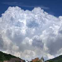 Large Poofy clouds over the hills