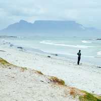 Surfer standing and looking at the waves in Cape Town, South Africa