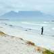 Surfer standing and looking at the waves in Cape Town, South Africa