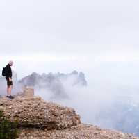 Man standing Landmark marker on the high mountains in Montserrat, Spain