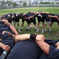 A team of Rugby players in a circle