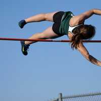 Woman Pole Vaulting over the bar