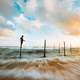 Time-Lapse landscape with fisherman under clouds and sky in Hikkaduwa, Sri Lanka