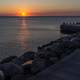 Sunset over the ocean at the shore and docks in Malmo, Sweden