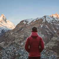 Man in Red Jacket looking at the Alps in Zermatt, Switzerland