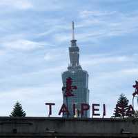 Taipei Tower with sign in front under the sky in Taiwan
