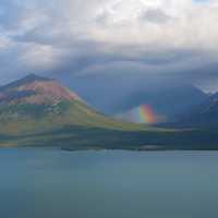 Rainbow coming out from the clouds in Lake Clark National Park
