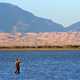 Man fishing while standing in the lake