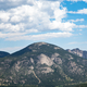 High Mountain with trees and clouds