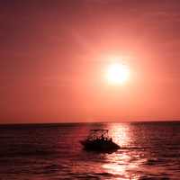 Boat under the red sun at Key West, Florida