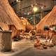 Native Americans working besides houses at Cahokia Mounds, Illinois