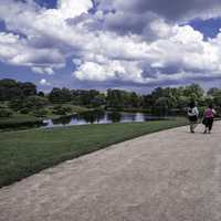 People walking on the path under the clouds landscape