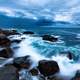 Waves of the ocean crashing on shore with skies in Acadia National Park