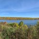 Autumn landscape across the river under the skies